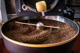 Freshly roasted coffee turning in the cooling tray at the Hinba roastery